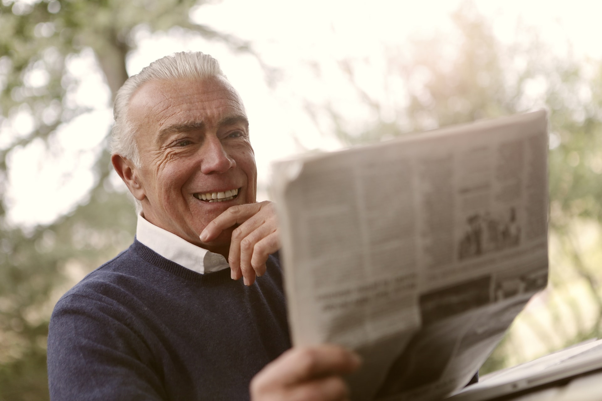 Happy man reading newspaper - Overcoming Home Care Resistance In Alzheimer's Patients | Alzheimer's Home Health Care in London
